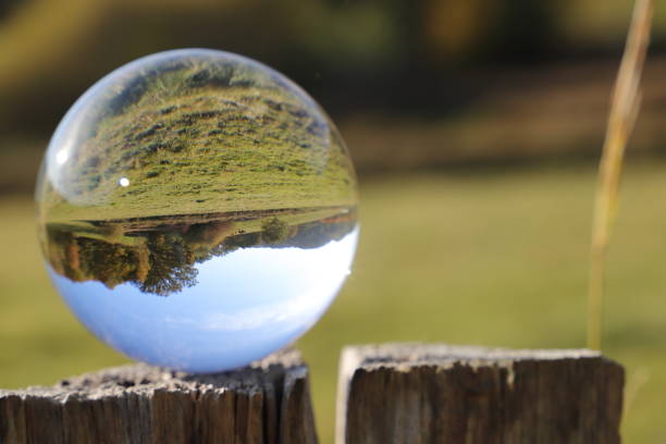 istock landscape photographed through a lens ball 1441395594
