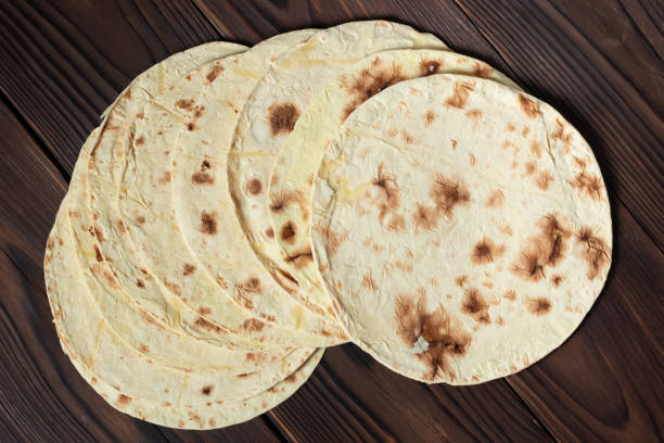 istock Taco flatbread lavash isolated on wooden background 1441398138