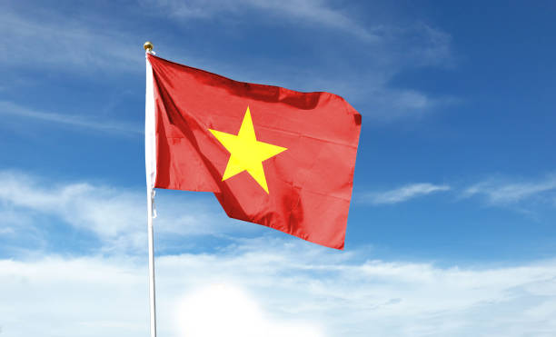 istock Vietnam flag on cloudy sky. waving in the sky 1441398331