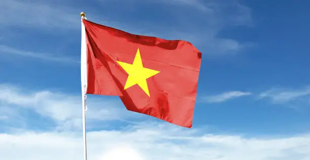 Vietnam flag on cloudy sky. waving in the sky