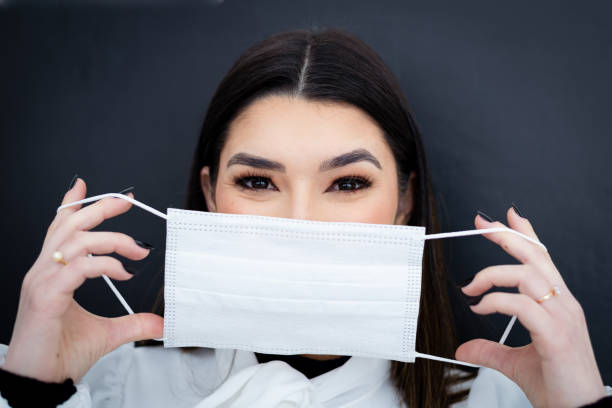 istock A beautiful young woman wearing mask 1441399905