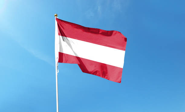 istock Austrian flag on cloudy sky. waving in the sky 1441401089
