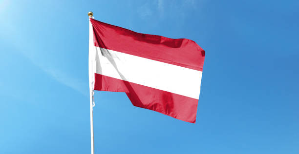 istock Austrian flag on cloudy sky. waving in the sky 1441401335