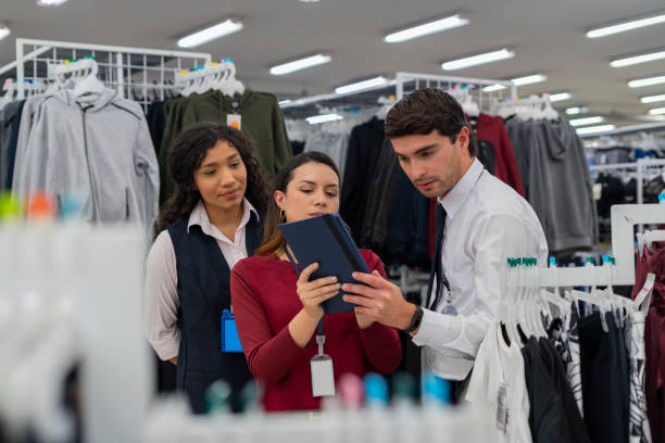 istock Warehouse manager trains his employees while showing them around the warehouse 1441403153