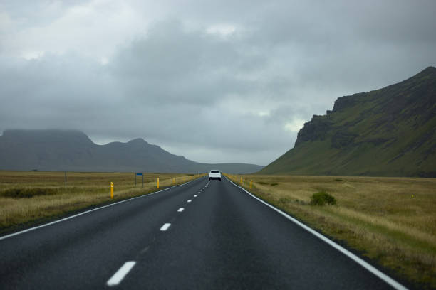istock Single car on an open road on Iceland 1441405473
