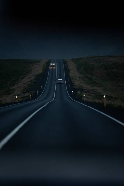 Long open road by night in Iceland stock photo