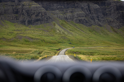 Open road on a remote location on Iceland, view from the inside of a car