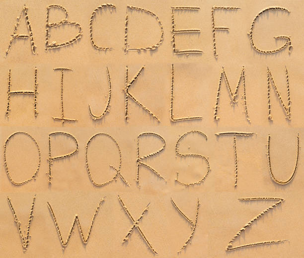 istock Alphabet letters handwritten in sand on beach 1441405661