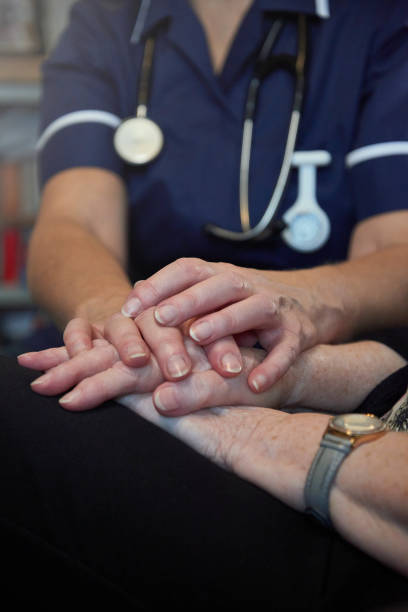istock Nurse comforting senior patient 1441405833