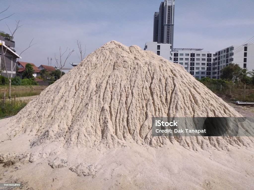 Sand pile on a construction site in the city washed by raindrops. Built Structure Stock Photo