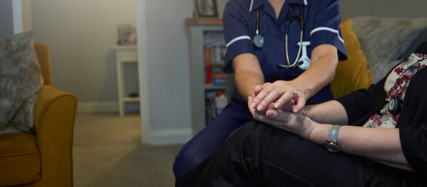 istock Nurse comforting senior patient 1441405907