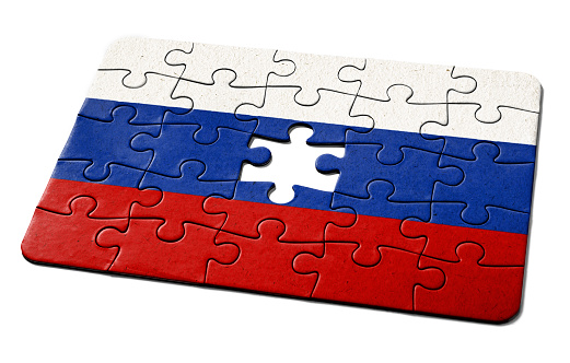 Russian national flag printed on a jigsaw puzzle with lots of texture, representing a government or political problem to be solved.