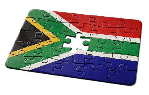 South African national flag printed on a jigsaw puzzle with lots of texture, representing a government or political problem to be solved.