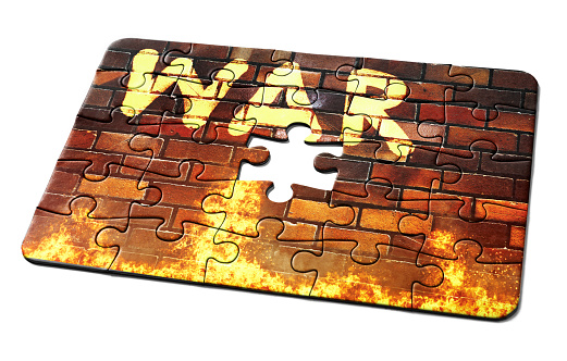 WAR sprayed on a wall, represented as a jigsaw puzzle with one missing piece.
