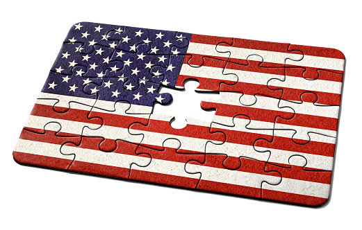 American national flag, the Stars and Stripes, printed on a jigsaw puzzle with lots of texture, representing a government or political problem to be solved.