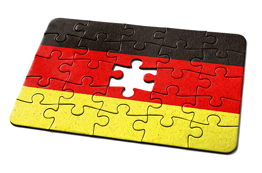 German national flag printed on a jigsaw puzzle with lots of texture, representing a government or political problem to be solved.