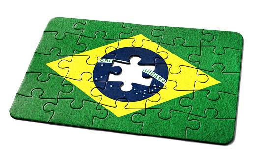 Brazilian national flag printed on a jigsaw puzzle with lots of texture, representing a government or political problem to be solved.