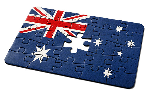 Australian national flag printed on a jigsaw puzzle with lots of texture, representing a government or political problem to be solved.
