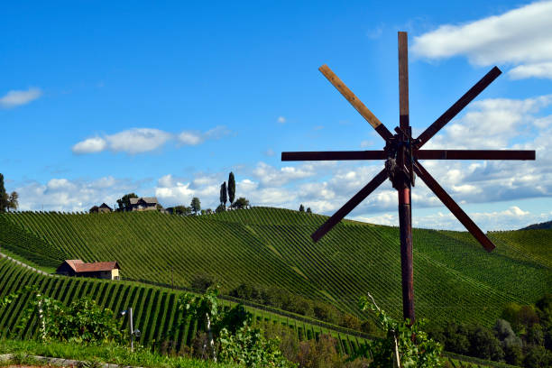 Austria, traditional Klapotez scarecrow and vineyards on the steep slopes located on the Styrian wine route, the hilly landscape is also known as the Tuscany of Austria, Klapotetz are used in south-eastern Austria by their clatter they drive the birds from the vines