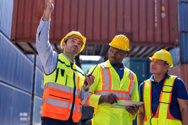 istock Engineer working in container storage yard satnd front of container lift truck ready to delivery 1441411430