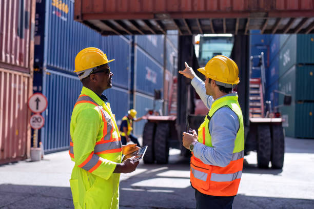 istock Engineer working in container storage yard satnd front of container lift truck ready to delivery 1441411538