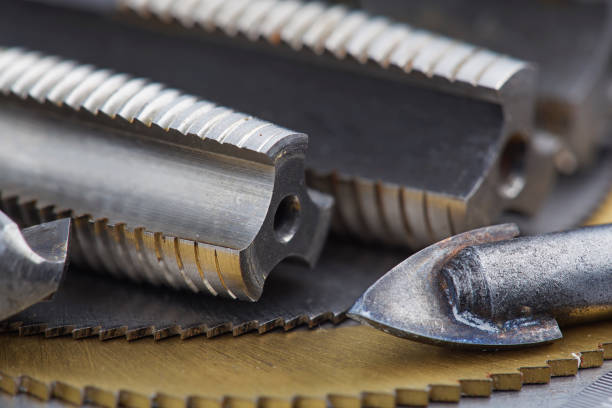istock set of different drill bits,thread tap and mill cutters with caliper ruler on steel plate background. Locksmithing deal. 1441412983