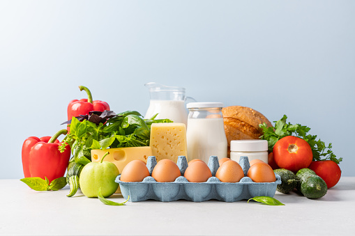 Close up view of eggs, dairy products, vegetables, fruits, bread. Healthy eating