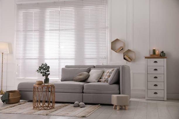 istock Living room with comfortable grey sofa and stylish interior elements near window 1441416017
