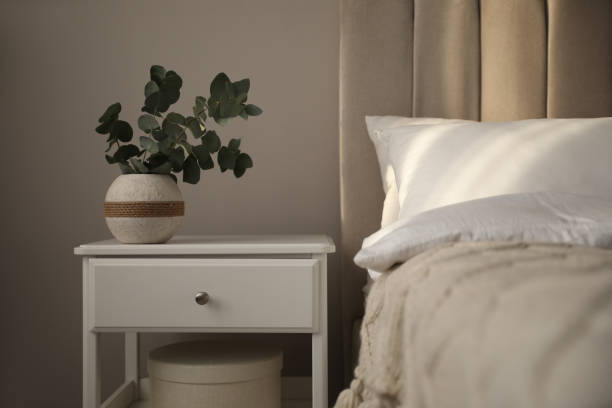 istock Vase with beautiful eucalyptus branches on nightstand in bedroom 1441416019