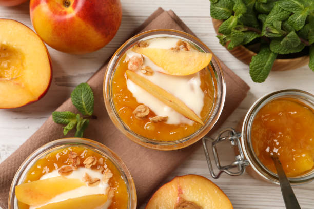 istock Flat lay composition with tasty peach yogurt on white wooden table 1441416444