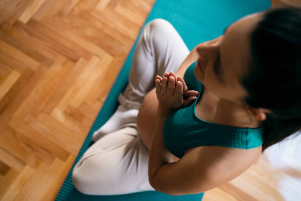 istock Pregnant woman practicing yoga at home 1441416457