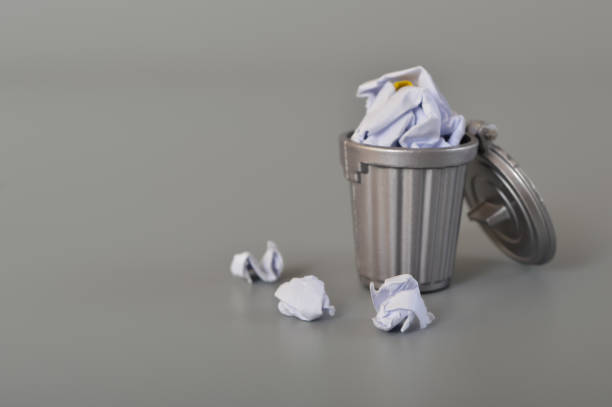 istock Tracy can with full of garbage isolated on a grey background. Cody space for the text. 1441416536