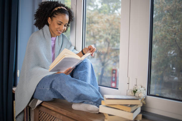 istock Woman relaxing and reading a book 1441416558