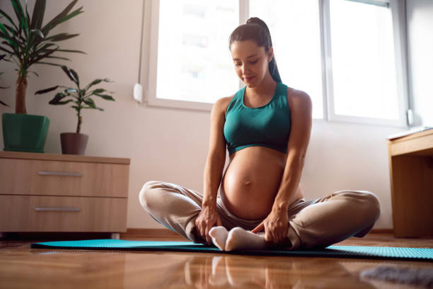 istock Pregnant woman practicing yoga at home 1441416778