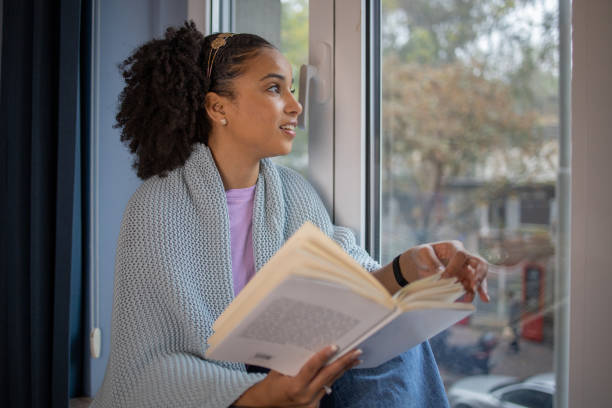 istock Woman relaxing and reading a book 1441416873