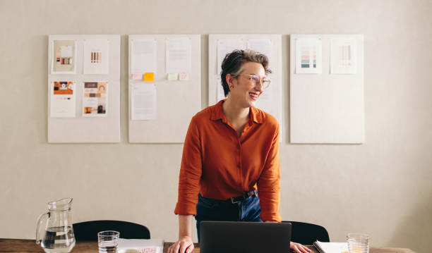 istock Happy interior designer looking away with a smile in a creative office 1441416963