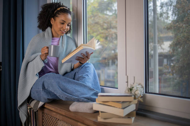 istock Woman relaxing and reading a book 1441417004