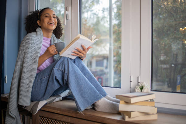 istock Woman relaxing and reading a book 1441417682