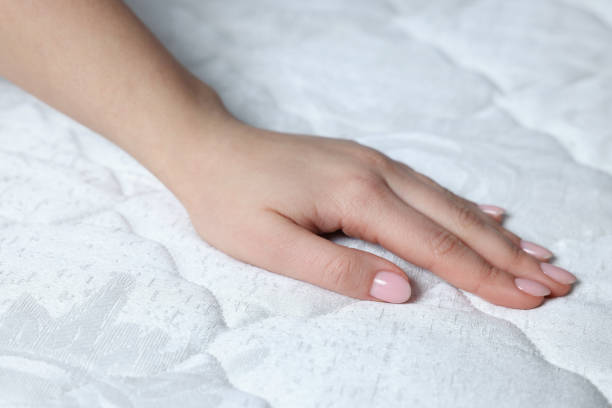istock Woman touching soft white mattress, closeup view 1441417739