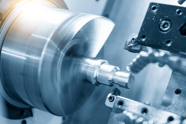 The CNC lathe machine thread cutting at the end of metal stud parts. stock photo