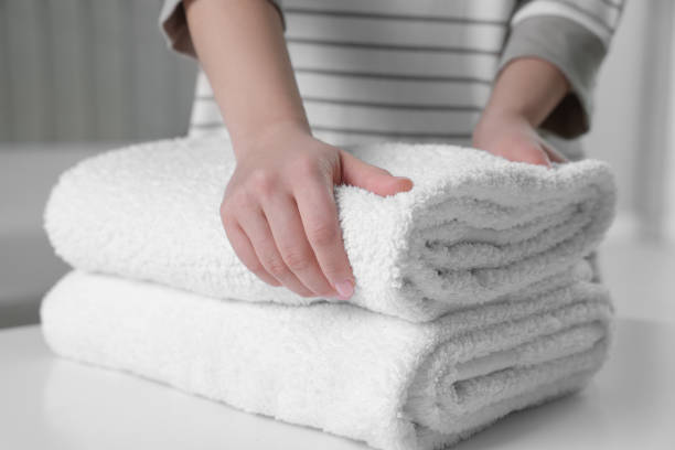istock Woman touching soft white towel indoors, closeup 1441417748