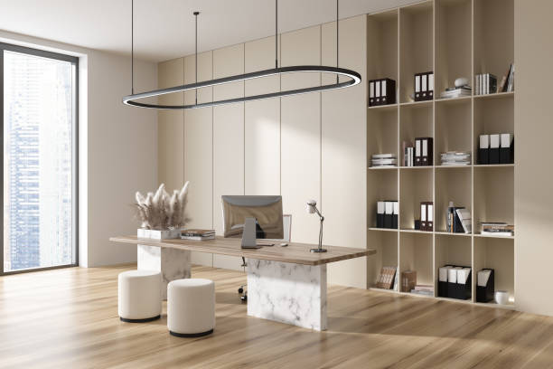 istock Stylish office interior with desk and pc computer, shelf and panoramic window 1441417750