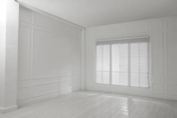 istock Empty room with white walls, large window and wooden floor 1441417859