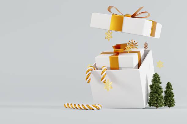 istock A gift in a gift box on a light background and a small Christmas tree and snowflakes. 1441417880