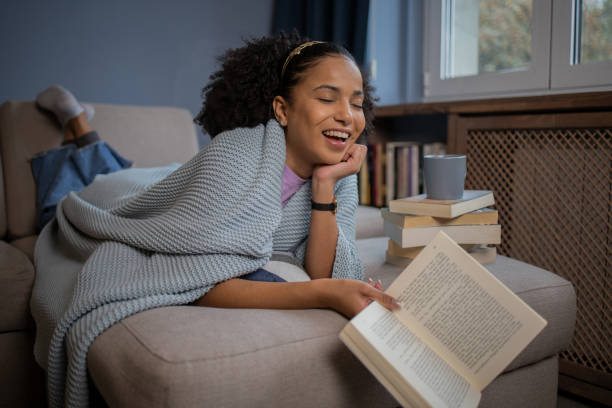 istock Woman relaxing and reading a book 1441417922