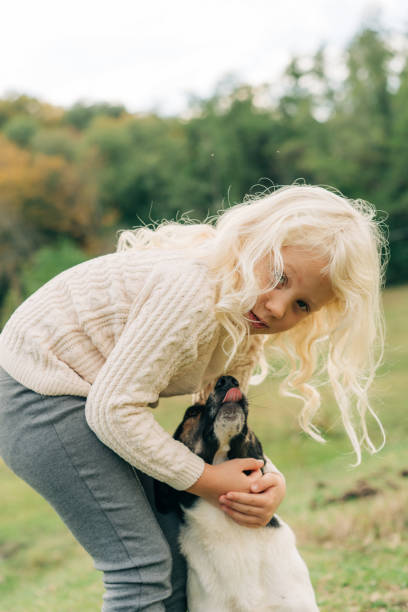 istock A little girl is hugging her dog. 1441418083