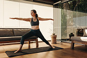  Mature woman doing the warrior pose during yoga