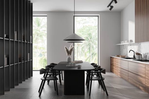 istock Stylish kitchen interior with table and chairs, shelf and panoramic window 1441418336