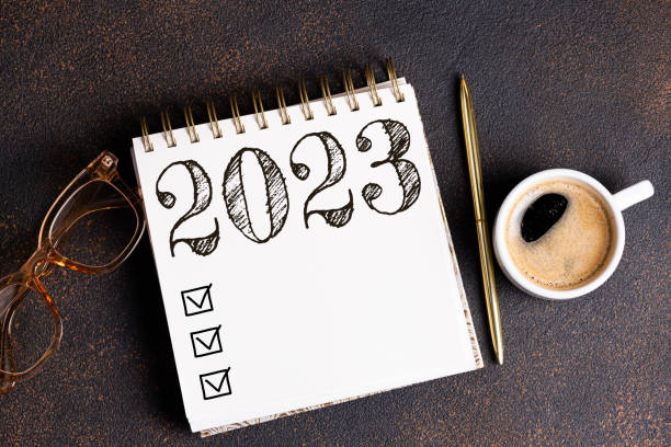istock New year resolutions 2023 on desk. 2023 resolutions list with notebook, coffee cup on table. Goals, resolutions, plan, action, checklist concept. New Year 2023 template 1441419551