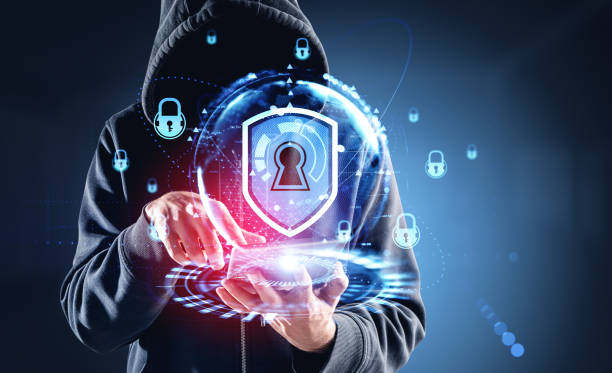 istock Hacker wearing casual wear holding tablet device with digital in 1441419562